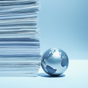 blue globe next to stack of papers