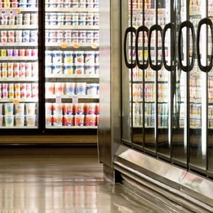 aisle of frozen and refrigerated foods at a grocery store