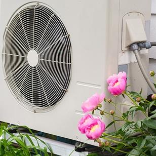 air conditioning heat pump unit on side of a home