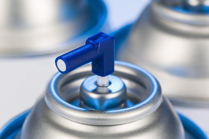closeup of top of spray aerosol can nozzle