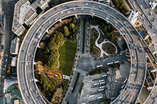 Looking down on a roundabout with cars on it from the sky
