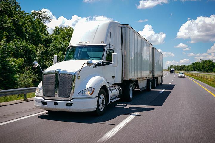 cwhite tractor trailer semi truck double trailer on the road