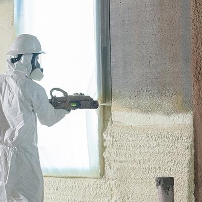 person spraying polyurethane foam insulation