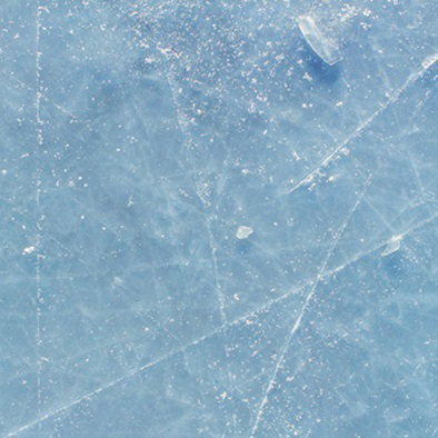 close up of ice with ice skate marks