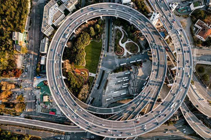 top down view of a busy circular intersection above another busy intersection