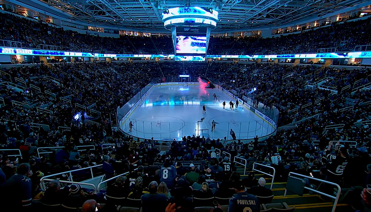 NHL hockey rink with blue lights and players on the ice