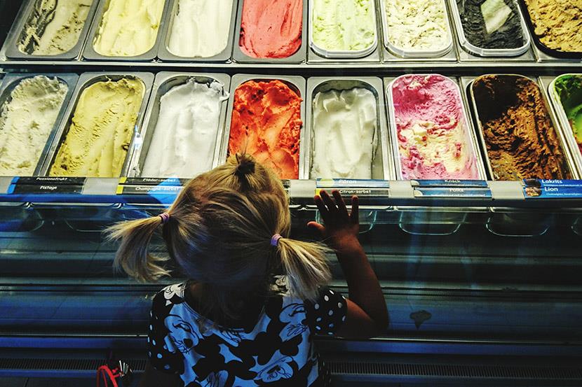 aerial view of little girl looking at ice cream display