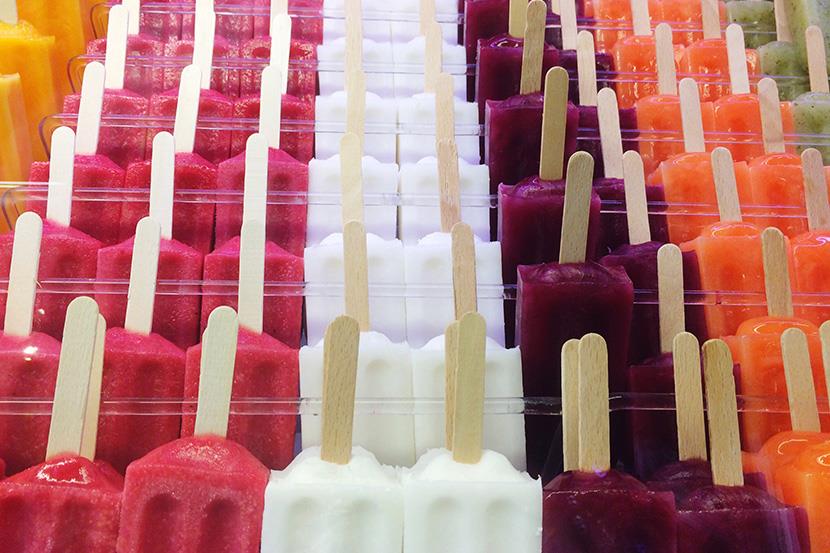 colorful display of orange red white purple orange and green popsicles